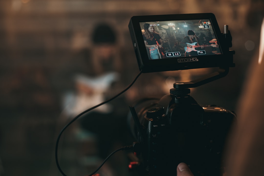 person-captures-woman-playing-guitar-from-the-camera-5muw-nho5i4